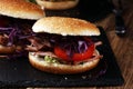 Pulled pork sandwiches with BBQ sauce, cabbage and tomato on tab Royalty Free Stock Photo