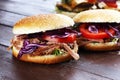Pulled pork sandwiches with BBQ sauce, cabbage and tomato on tab Royalty Free Stock Photo