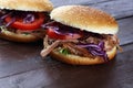 Pulled pork sandwiches with BBQ sauce, cabbage and tomato on tab Royalty Free Stock Photo