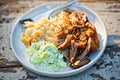 Pulled, seasoned pork, with mashed fried potatoes and cucumber and sour cream salad Royalty Free Stock Photo