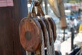 Closeup of a wooden pulley with ropes on the replica of the Santa Maria caravel Royalty Free Stock Photo