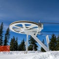 Pulley wheel from the top of a ski lift with a blue sky background Royalty Free Stock Photo