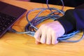 Pulling the blue usb cable from the laptop with force by a person Royalty Free Stock Photo