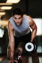 Pulling his weight. Portrat of a handsome man wearing sports clothing and lifting weights at the gym. Royalty Free Stock Photo