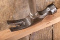 Pulling out nails from a piece of wood using a carpenter& x27;s hammer. Small carpentry work in the workshop Royalty Free Stock Photo