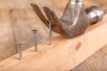 Pulling out nails from a piece of wood using a carpenter& x27;s hammer. Small carpentry work in the workshop Royalty Free Stock Photo