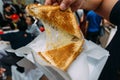 Pulling separate a Grilled Cheese Toast by hand with stretching cheese inside Royalty Free Stock Photo