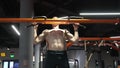 pullup. strong sportsman practicing pullup in sport gym. sportsman do pullup workout. sportsman