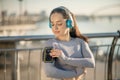 Fit girl in grey sportswear fattaching the pulsometer on her arm Royalty Free Stock Photo