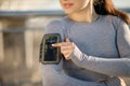 Fit girl in grey sportswear fattaching the pulsometer on her arm Royalty Free Stock Photo