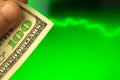 Pulse of dollar currency concept, man hold US dollar bill in hand on background of green stock chart graphs Royalty Free Stock Photo