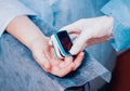 Pulse oximeter on the patient`s hand. Surgery equipment. Royalty Free Stock Photo