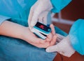 Pulse oximeter on the patient`s hand. Surgery equipment. Royalty Free Stock Photo