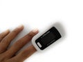 Pulse oximeter on white background. Close up of Finger and hand in an Oximeter Device.