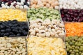 Pulses food background, assortment - legume, kidney beans, peas, lentils in square cells macro.