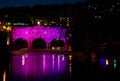 Pulteney Bridge illuminated in pink at night in Bath, Somerset, UK Royalty Free Stock Photo