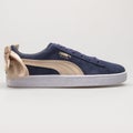 Puma Suede Bow Varsity navy blue and gold sneaker Royalty Free Stock Photo