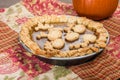 Pumkin pie with decorated crust and a pumpkin Royalty Free Stock Photo