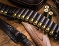 Pump action shotgun,  12 guage cartridge and hunting knife Royalty Free Stock Photo