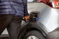 Pump gas at gas station while put nozzle by hand in car hole to refuel the tank with diesel next to ad blue cap Royalty Free Stock Photo