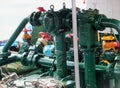 Pump gear and valves on a working vessel painted in dark green