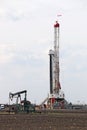 Pump jack and land oil drilling rig Royalty Free Stock Photo