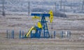 Pump Jack. Oilfield derrick.Oilfield pump for oil production. Vegetation covered with hoar-frost