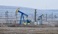 Pump Jack. Oilfield derrick.Oilfield pump for oil production. Vegetation covered with hoar-frost Royalty Free Stock Photo