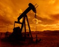 A pump jack at sunset in a Wyoming oil field Royalty Free Stock Photo