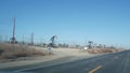 Pump jacks on oil field, USA. Rigs for crude fossil extraction on oilfield wells Royalty Free Stock Photo