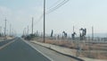 Pump jacks on oil field, USA. Rigs for crude fossil extraction on oilfield wells Royalty Free Stock Photo