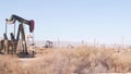 Pump jacks on oil field, USA. Rigs for crude fossil extraction on oilfield wells Royalty Free Stock Photo