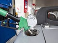 Pump refilling car with fuel at gas station Royalty Free Stock Photo