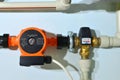 Pump with a thermometer for a water underfloor heating system at home. Sensor and temperature control. Manometer, pipe,