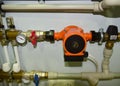 Pump with a thermometer for a water underfloor heating system at home. Sensor and temperature control. Manometer, pipe, flow meter
