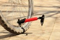 Pumping bicycle wheel red bicycle pump. Royalty Free Stock Photo