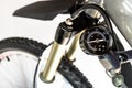 Pumping of the front, bicycle oil-air shock absorber using a specialized pump, visible pressure indicator in units of bar / psi. Royalty Free Stock Photo