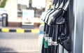 Pumping gas and diesel at pump. Close-up of a fuel pistol for refueling gasoline and diesel. Royalty Free Stock Photo