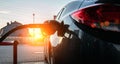 Pumping gas fuel car at oil station. Woman hand refuel petrol nozzle tank. Refueling transportation and Automotive Royalty Free Stock Photo