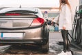 Pumping gas fuel car at oil station. Woman hand refuel petrol nozzle tank. Refueling transportation and Automotive industry Royalty Free Stock Photo