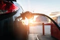 Pumping gas fuel car at oil station. Woman hand refuel petrol nozzle tank. Refueling transportation and Automotive Royalty Free Stock Photo