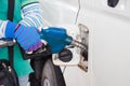 Pumping gas at gas pump. Closeup of man pumping gasoline fuel in Royalty Free Stock Photo