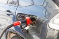 Pumping gas at pump. Closeup of man gasoline fuel in car station. Royalty Free Stock Photo