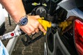 Pumping gas at gas pump. Closeup of man pumping gasoline fuel in car at gas station Royalty Free Stock Photo