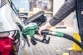 Pumping gas at pump. woman with handr efueling gasoline fuel in car at petrol station. Royalty Free Stock Photo