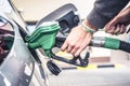 Pumping gas at pump. woman with handr efueling gasoline fuel in car at petrol station. Royalty Free Stock Photo