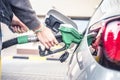 Pumping gas at pump. woman with handr efueling gasoline fuel in car at petrol station. Royalty Free Stock Photo