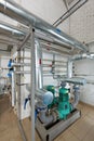 Pumping station in an industrial gas boiler house with a multitude of pipes; Pumps and valves Royalty Free Stock Photo