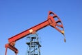 pumping unit walking beam under blue sky Royalty Free Stock Photo