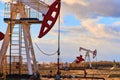 A pumpjack is the overground drive for a reciprocating piston pump in an oil well Royalty Free Stock Photo